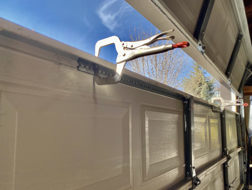 Cracked and Bent Garage Door Panel Reinforced With Integrated Steel Rail